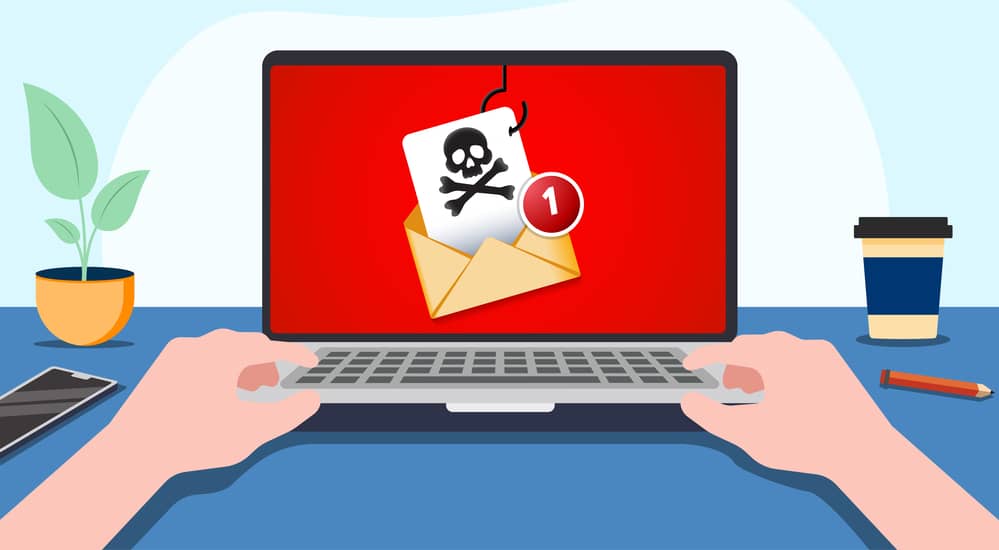 Ilustración de una persona usando una laptop donde aparece un correo electrónico con un anzuelo y una calavera (símbolo de peligro), representando un ataque de baiting.