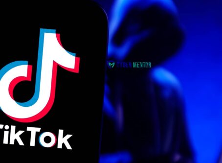 El logo de TikTok en una pantalla de teléfono inteligente, con una figura encapuchada y difuminada al fondo, sugiriendo un contexto de cibercrimen. El logo de Cyber Mentor también está presente.